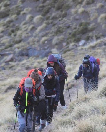 Travellers climbing a mountain trail